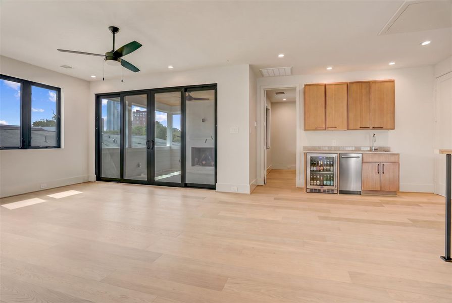 The third floor features a large game room with wet bar and direct access to the covered terrace with outdoor fireplace, TV connections, and Galleria area views.