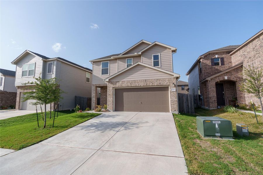 Modern two-story home features a spacious driveway and a neatly manicured lawn. Modern two-story home features a spacious driveway and a neatly manicured lawn.