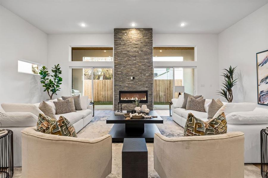 Living room featuring a fireplace and a high ceiling