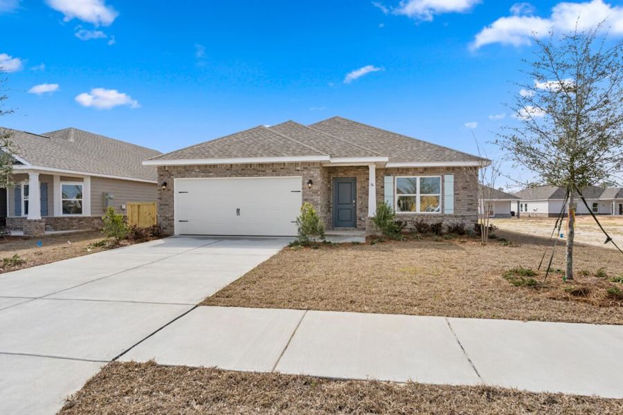 Front exterior of a new home in Natureview, Freeport, FL, highlighting curb appeal (Image 1). Front exterior of a new home in Natureview, Freeport, FL, highlighting curb appeal (Image 1).