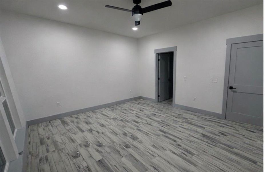 Unfurnished bedroom with light wood-style floors, ceiling fan, and recessed lighting
