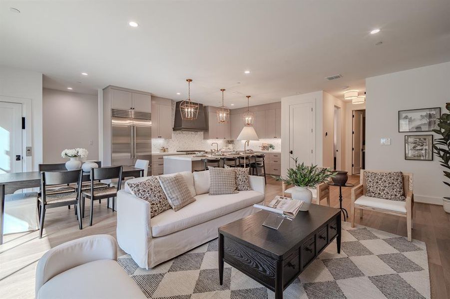 Living area with light wood-style floors and recessed lighting Living area with light wood-style floors and recessed lighting