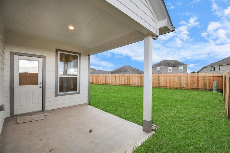 Step into a world of outdoor possibilities with this remarkable backyard and its charming covered patio. From playtime for the kids to relaxation for the adults, this space offers the best of both worlds.