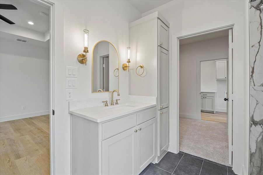 Bathroom featuring vanity, tile patterned flooring, and ceiling fan