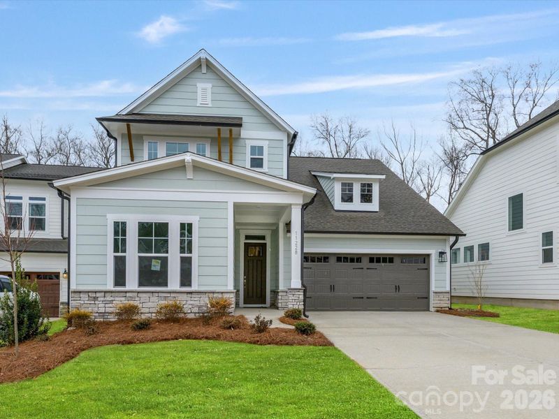 Front exterior of a new home in North Creek Village, Huntersville, NC, highlighting curb appeal (Image 2). Front exterior of a new home in North Creek Village, Huntersville, NC, highlighting curb appeal (Image 2).