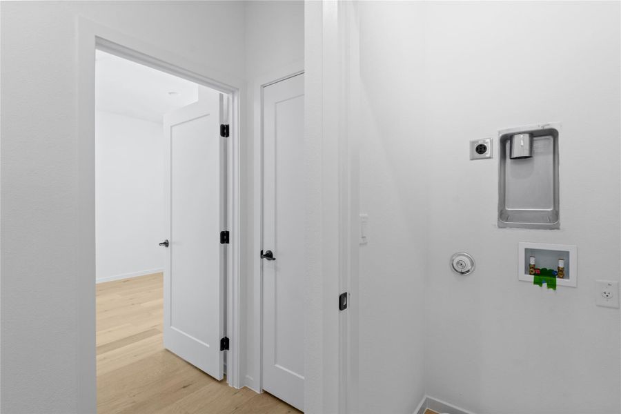Hallway with light wood-style floors
