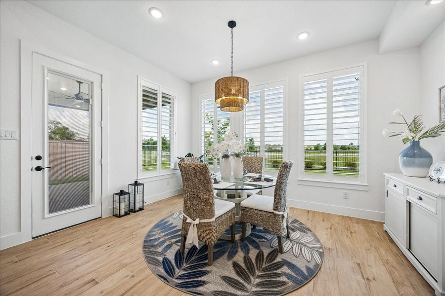 Dining room view featuring direct access to the outdoor patio and a recessed wall niche ideal for a future built-in display or furniture placement.