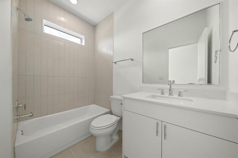 A view of the third bedroom bathroom with beautiful neutral design choices.