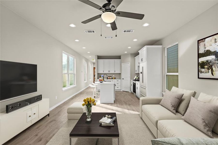 *Virtually Staged* Living room with light hardwood / wood-style flooring, ceiling fan, and sink