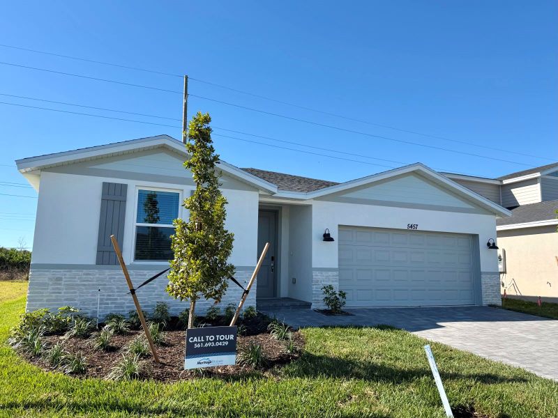 Front exterior of a new home in Hampton Park - Classic Series, Vero Beach, FL, highlighting curb appeal (Image 10).