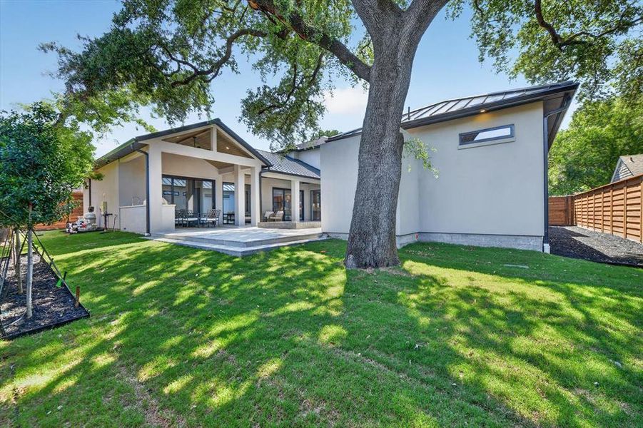 Contemporary exterior with a covered patio and extensive glass sliders, featuring a modern pitched roofline and light-colored stucco siding Contemporary exterior with a covered patio and extensive glass sliders, featuring a modern pitched roofline and light-colored stucco siding