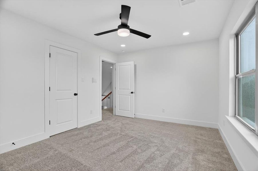 Neutral-toned carpeting complements white walls and trim