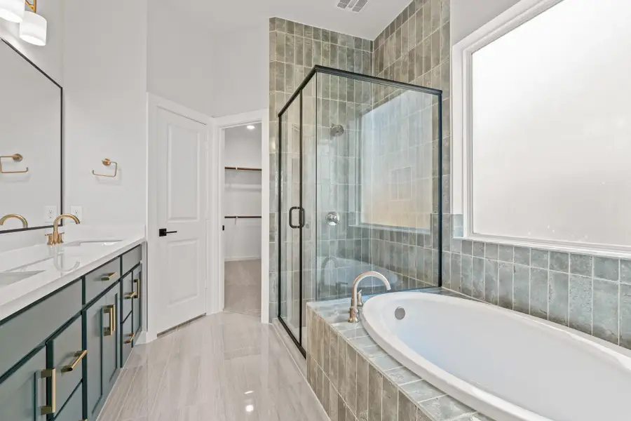 **REPRESENTATIVE PHOTO** The main bathroom exudes a spa-like ambiance with soothing green tones, such as soft sage and muted eucalyptus, creating a tranquil, nature-inspired retreat. Accents of natural wood and stone, paired with plush white towels, complete the serene, rejuvenating atmosphere. **REPRESENTATIVE PHOTO** The main bathroom exudes a spa-like ambiance with soothing green tones, such as soft sage and muted eucalyptus, creating a tranquil, nature-inspired retreat. Accents of natural wood and stone, paired with plush white towels, complete the serene, rejuvenating atmosphere.