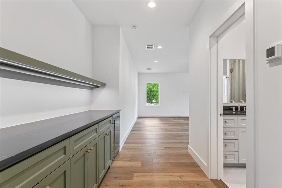 Entrance to game room with custom built in cabinets and beverage cooler