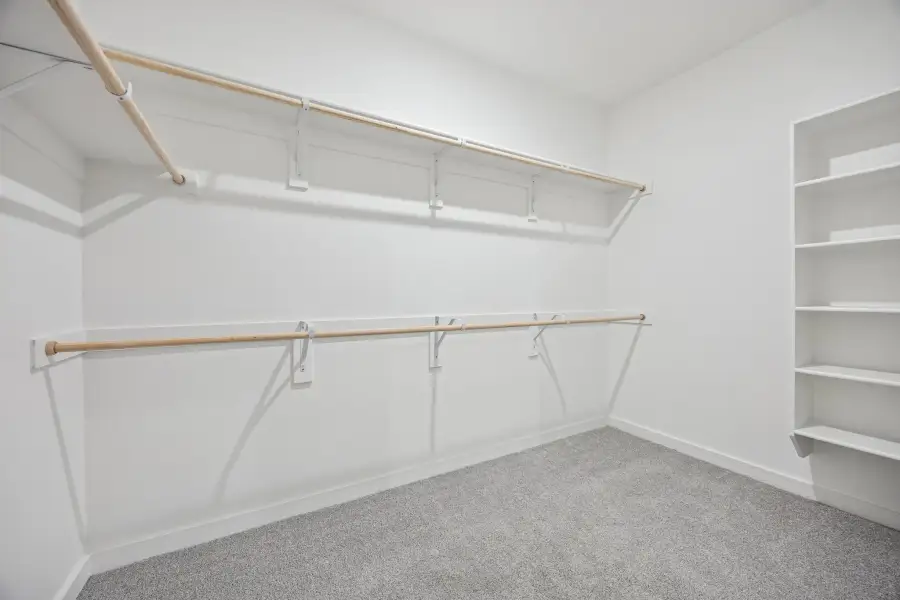 Primary Closet in the Oak II home plan by Trophy Signature Homes – REPRESENTATIVE PHOTO Primary Closet in the Oak II home plan by Trophy Signature Homes – REPRESENTATIVE PHOTO
