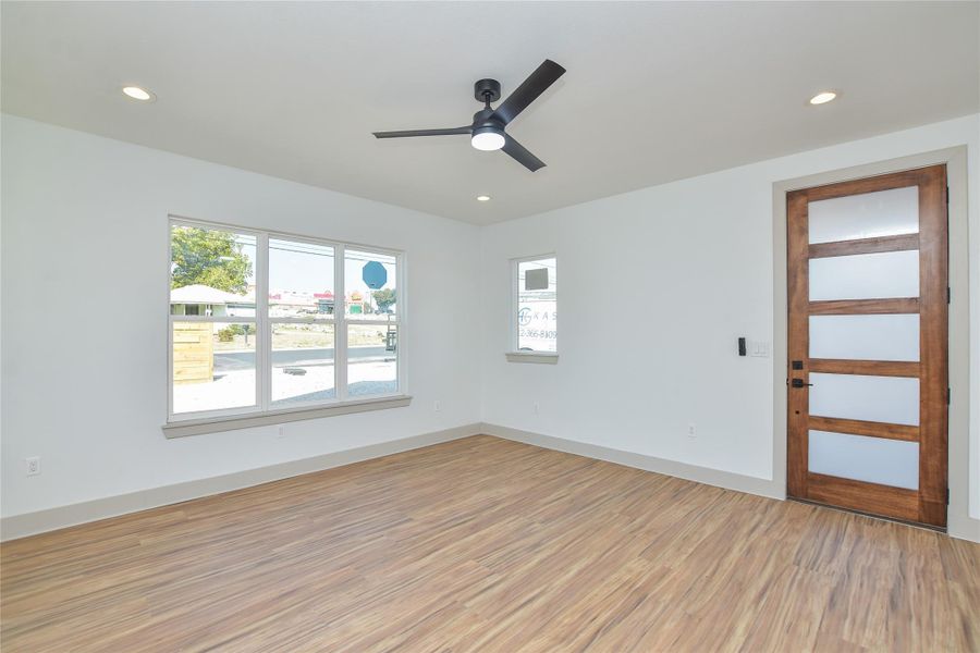 View of living area & front door. Lots of natural light.