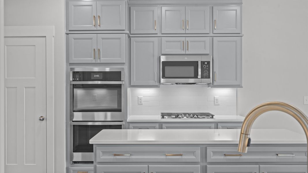 Exclusive DRB Homes kitchen with a 9-foot island, elevated finishes, and pendant lighting in a prime location