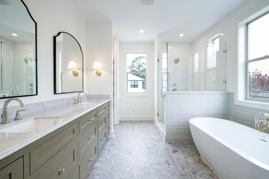 The primary bathroom boasts dual sinks, a separate shower and freestanding bathtub. There are two separate primary closets with built in cabinetry and hanging space. *Previous Project*