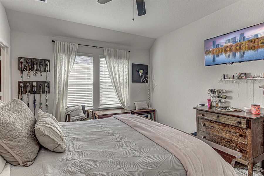 Bedroom featuring a textured wall and a ceiling fan