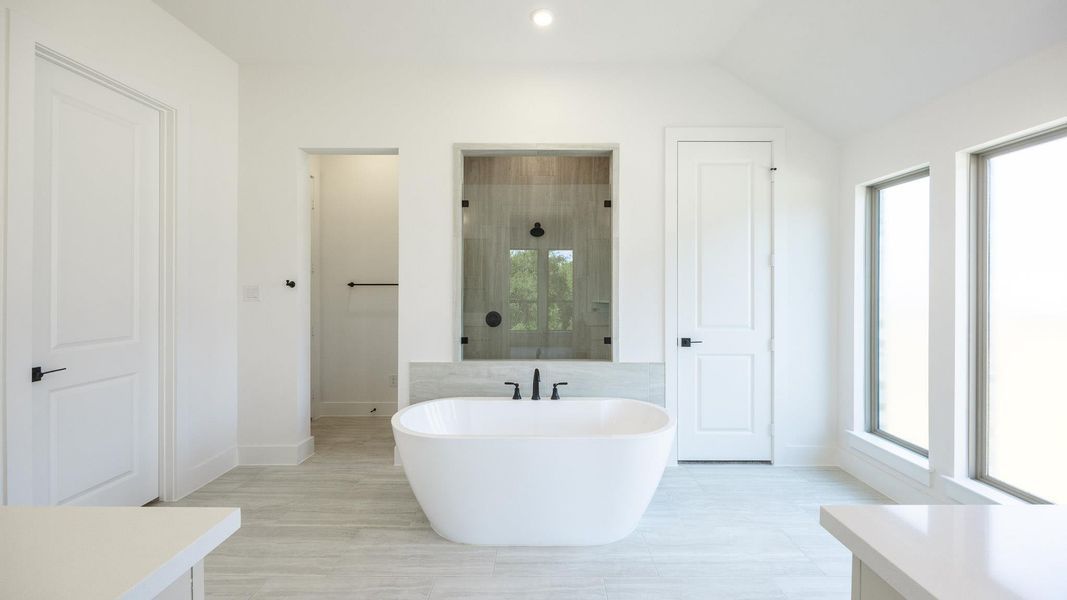 Bathroom with a freestanding tub and recessed lighting Bathroom with a freestanding tub and recessed lighting