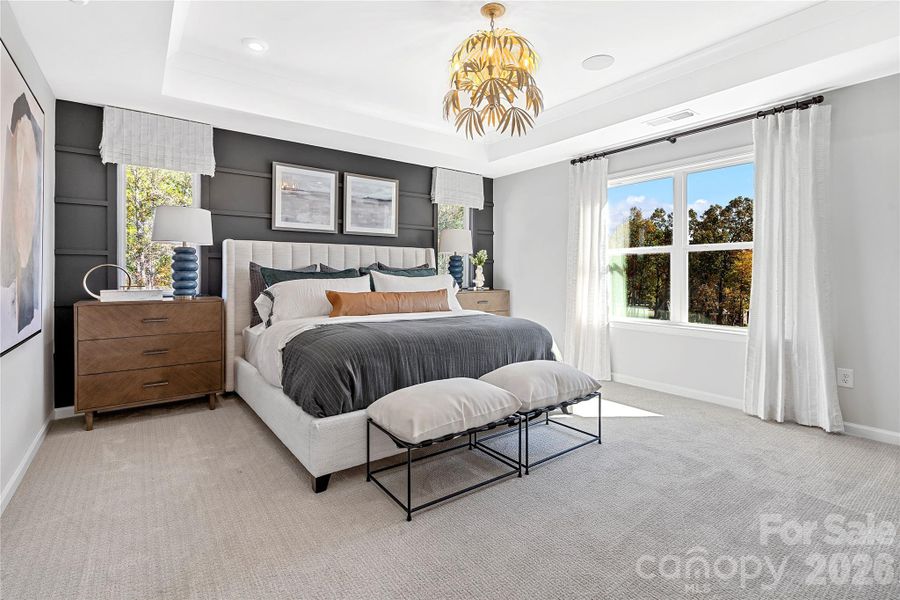 Primary suite with upgraded tray ceiling and accent wall. Primary suite with upgraded tray ceiling and accent wall.