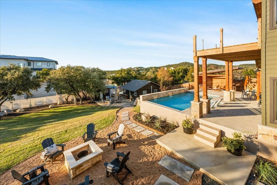 Large fenced backyard with a peek of the cabin