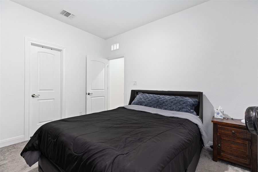 Bedroom featuring light carpet