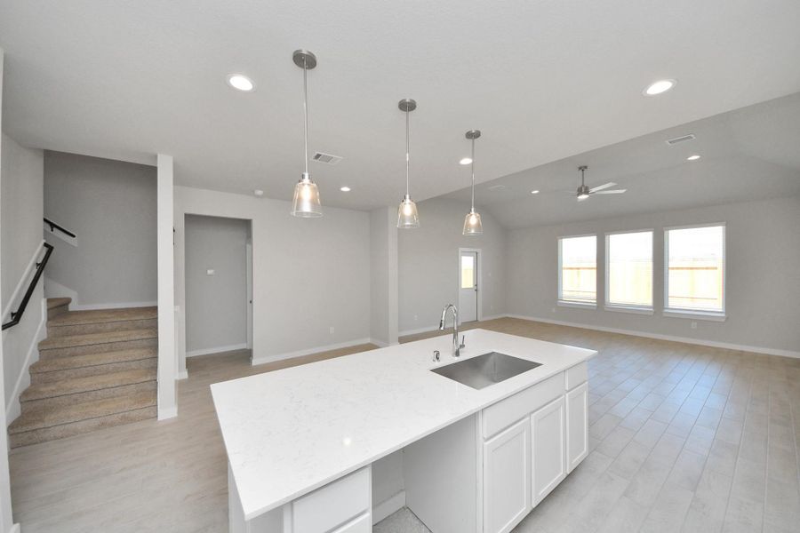 Discover another perspective of this stunning kitchen, generously appointed with an abundance of counter space. Sample photo of completed home with similar floor plan. Actual colors and selections may vary. Discover another perspective of this stunning kitchen, generously appointed with an abundance of counter space. Sample photo of completed home with similar floor plan. Actual colors and selections may vary.