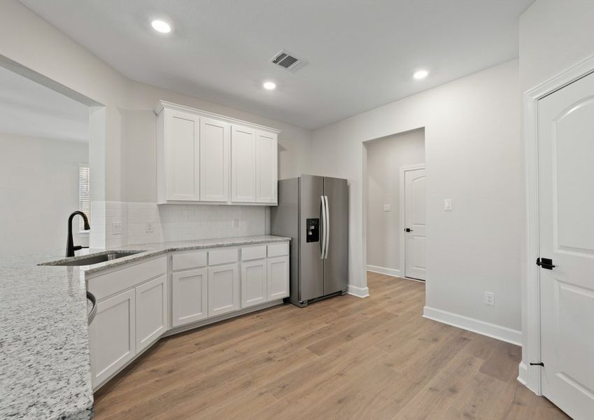 The upgraded kitchen has sprawling granite countertops. The upgraded kitchen has sprawling granite countertops.