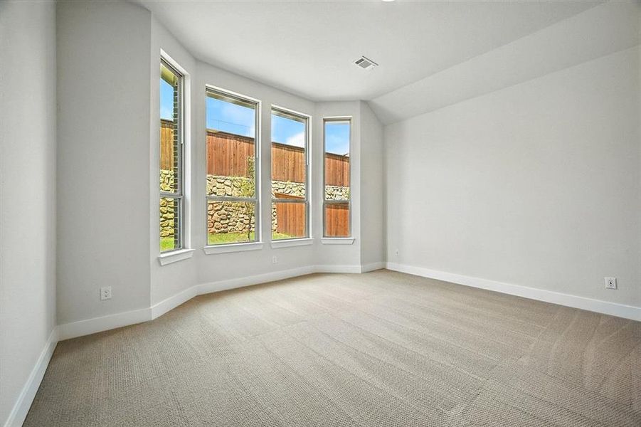 Spare room featuring light carpet and baseboards Spare room featuring light carpet and baseboards
