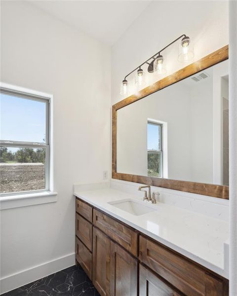 Bathroom with vanity and tile patterned flooring