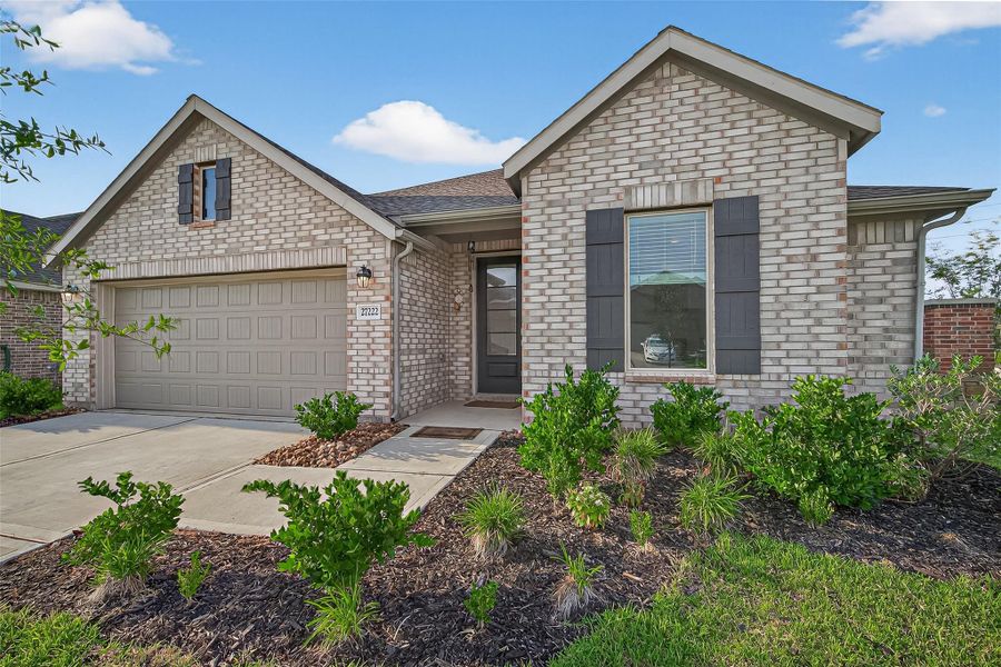 Front exterior of a new home in Sunterra, Katy, TX, highlighting curb appeal (Image 23). Front exterior of a new home in Sunterra, Katy, TX, highlighting curb appeal (Image 23).