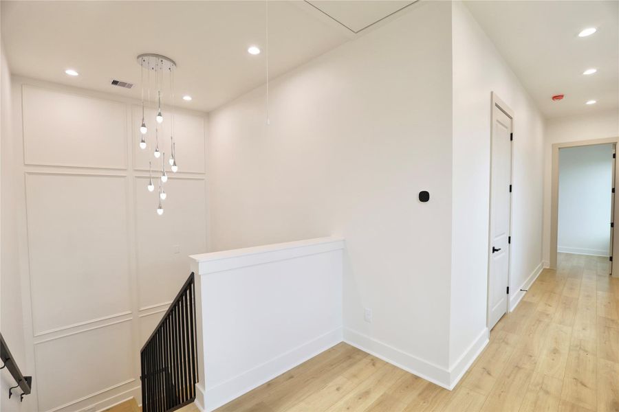 Comfort and control are elevated with dual-zone climate control—note the smart thermostat. The primary suite awaits through the door on the right side of the home, while the remaining bedrooms are thoughtfully placed on the opposite side for added privacy. Comfort and control are elevated with dual-zone climate control—note the smart thermostat. The primary suite awaits through the door on the right side of the home, while the remaining bedrooms are thoughtfully placed on the opposite side for added privacy.