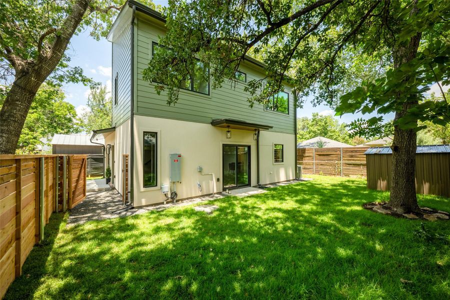 A well-maintained lawn and sturdy privacy fence frame this modern dwelling, offering ample outdoor enjoyment. A well-maintained lawn and sturdy privacy fence frame this modern dwelling, offering ample outdoor enjoyment.
