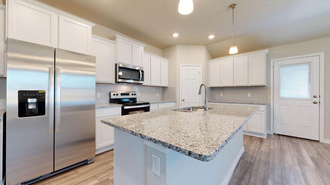 Modern kitchen featuring white cabinetry, light-toned granite countertops, stainless steel appliances, and wood-finish flooring