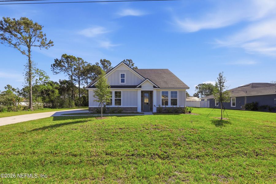 Front exterior of a new home in Palm Coast Homes, Palm Coast, FL, highlighting curb appeal (Image 28).