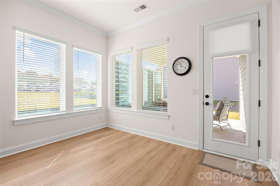 AREA OFF THE LIVING ROOM LOOKING OUT ON THE COVERED PORCH