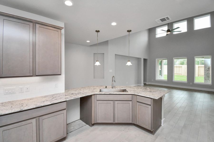 The extended counter area adds both practicality and style, making meal preparation a breeze. Every detail is thoughtfully designed to enhance the kitchen's functionality and aesthetic appeal. Sample photo of completed home with similar floor plan. Actual colors and selections may vary. The extended counter area adds both practicality and style, making meal preparation a breeze. Every detail is thoughtfully designed to enhance the kitchen's functionality and aesthetic appeal. Sample photo of completed home with similar floor plan. Actual colors and selections may vary.