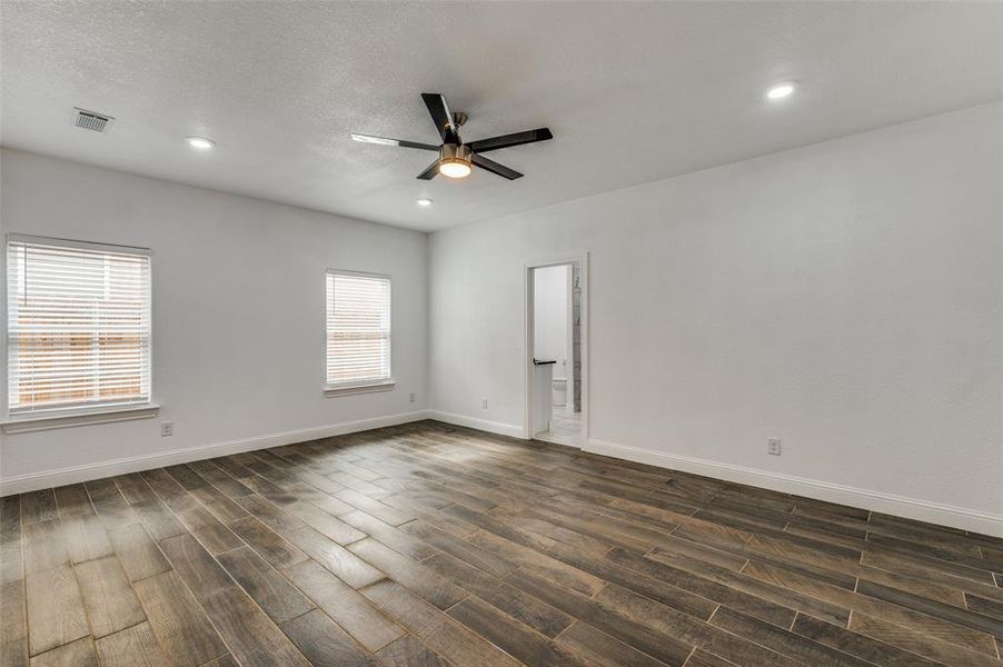 Unfurnished room featuring dark wood-style flooring, recessed lighting, ceiling fan, and a textured ceiling Unfurnished room featuring dark wood-style flooring, recessed lighting, ceiling fan, and a textured ceiling