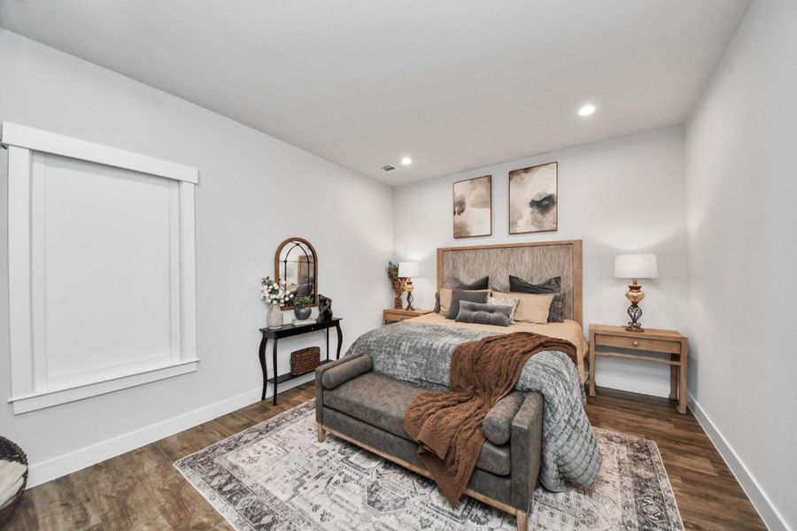Cozy bedroom featuring a stylish wooden bed, elegant side tables, and soft, neutral decor accents for a serene atmosphere.
