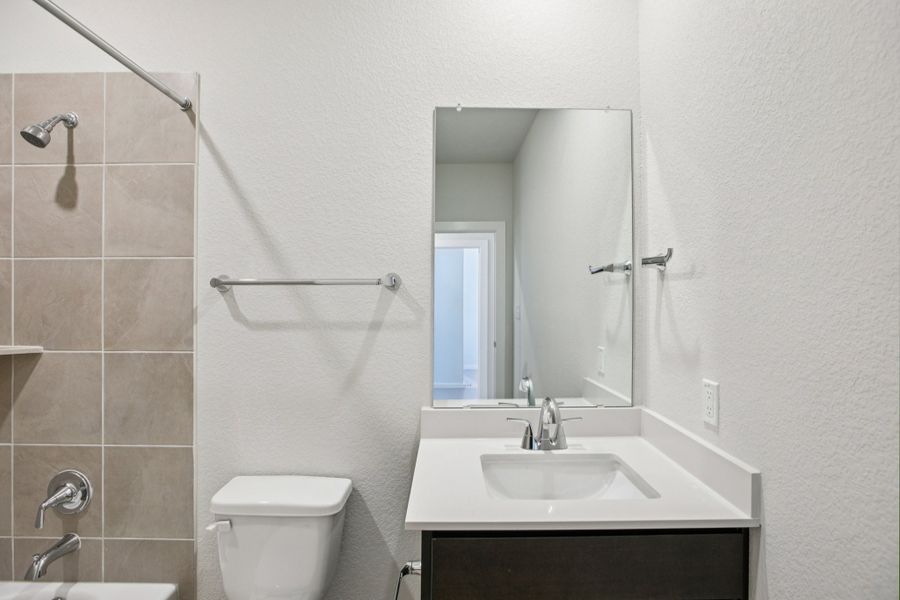 A bathroom with a sink and a toilet.