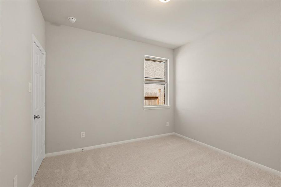 Your secondary bedroom features plush carpet, fresh paint, closet, and a large window that lets in plenty of natural lighting.