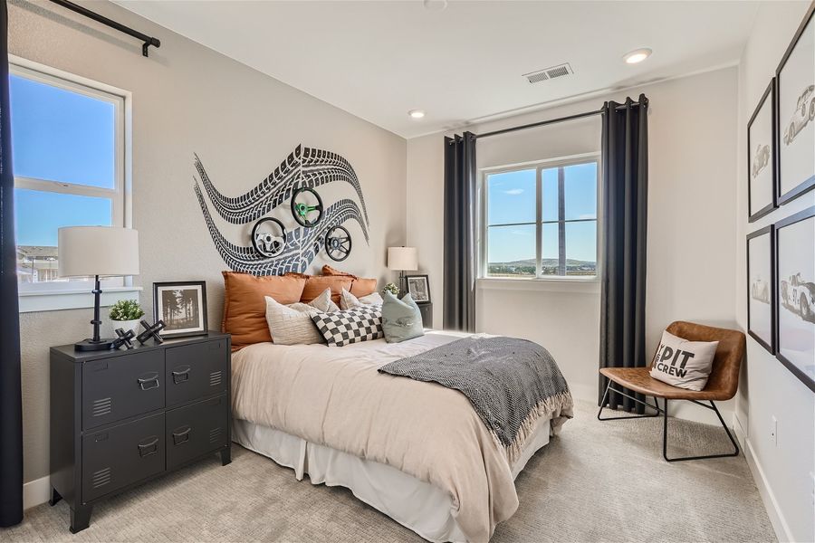 A bedroom with a bed and a chair. A bedroom with a bed and a chair.