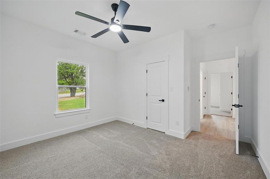 Unfurnished bedroom with carpet, baseboards, and ceiling fan