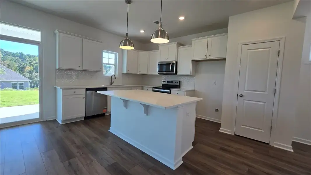 Rich wood floors anchor this kitchen with its cris