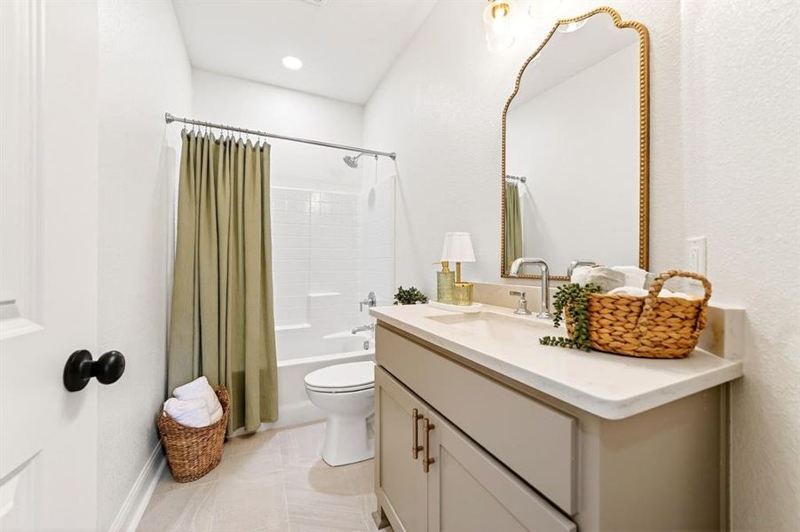 Contemporary bathroom featuring a single vanity with a solid surface countertop, an undermount sink, and a decorative mirror