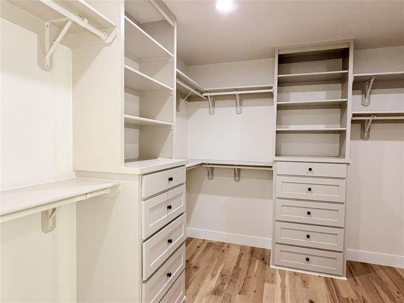 Walk in closet featuring light wood-style floors Walk in closet featuring light wood-style floors