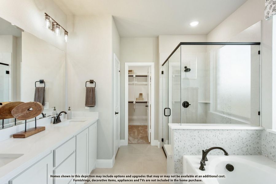 Master bathroom with double vanity, glass-enclosed shower, soaking tub, and walk-in closet entrance Master bathroom with double vanity, glass-enclosed shower, soaking tub, and walk-in closet entrance