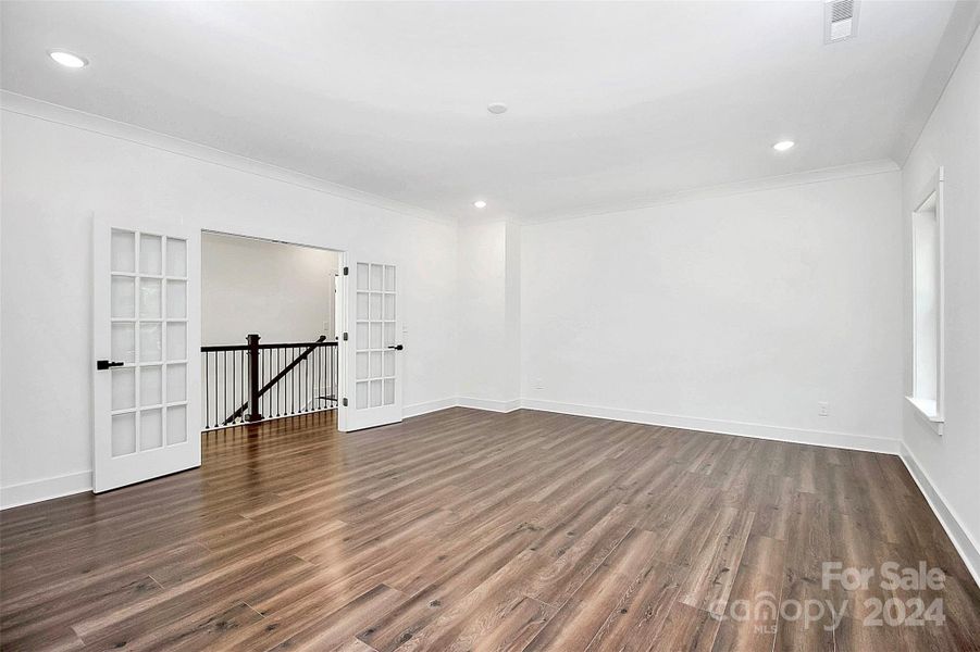 Huge bonus room with french doors.