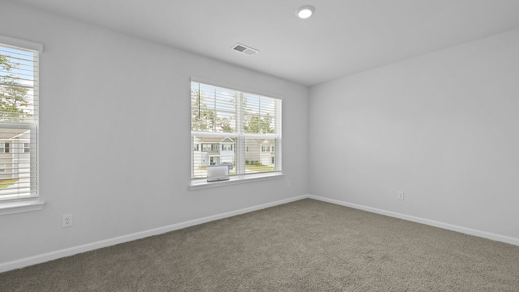 Spacious, unfurnished interior of a new home in Pine Hills Townhomes at Cane Bay, Summerville (Image 24).
